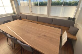 Großer Esstisch aus Eiche mit einer langen Sitzbank.