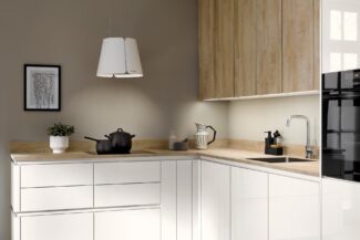 Kleine Küche in L-Form mit weißen Fronten und Eichenholz.